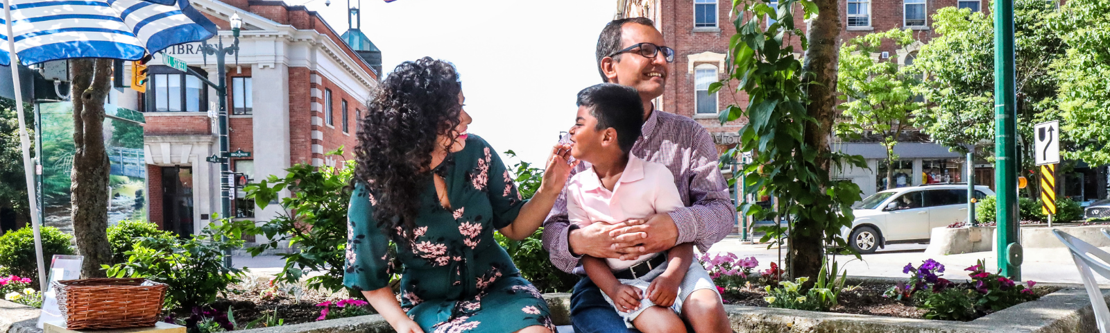 Family sitting on downtown bench